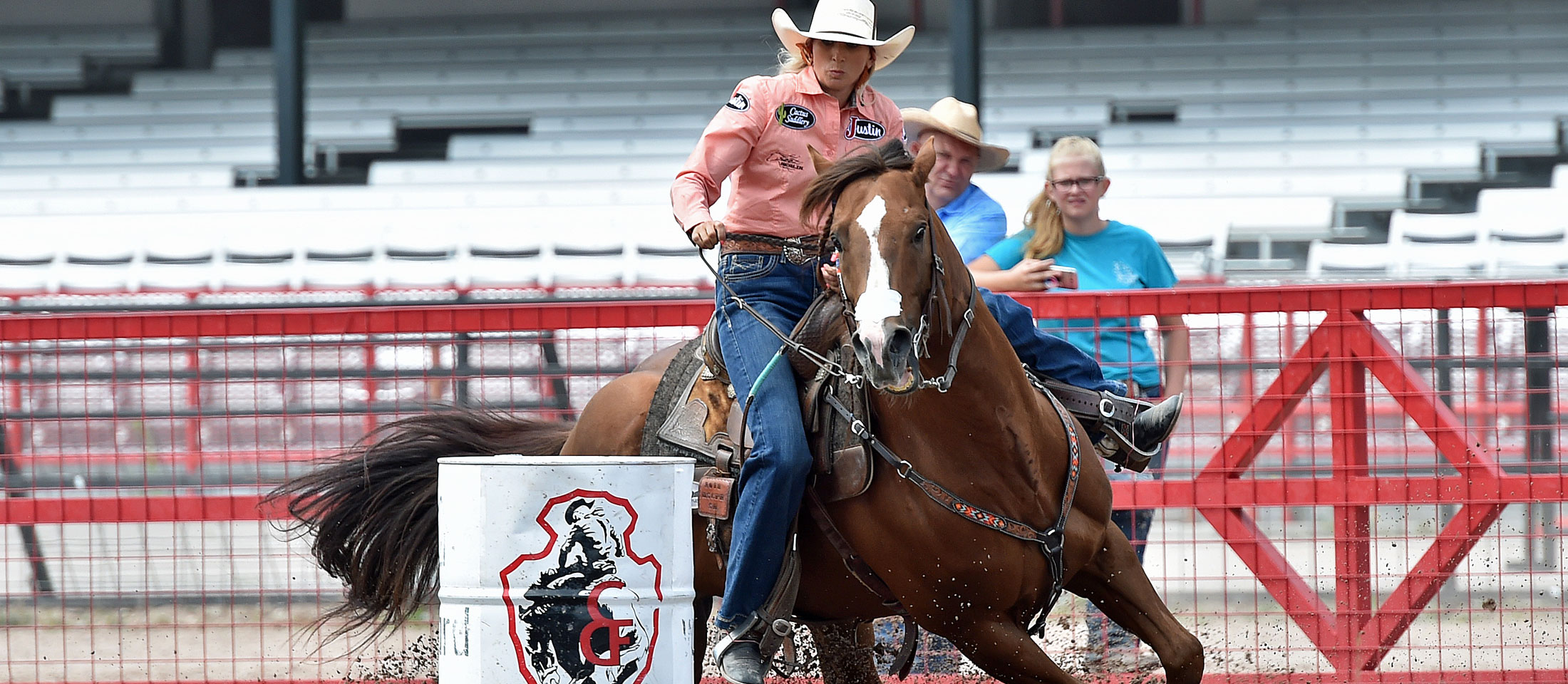 Barrel Racer Shali Lord and her horse turning a barrel at the Cheyenne Frontier Days Rodeo. 